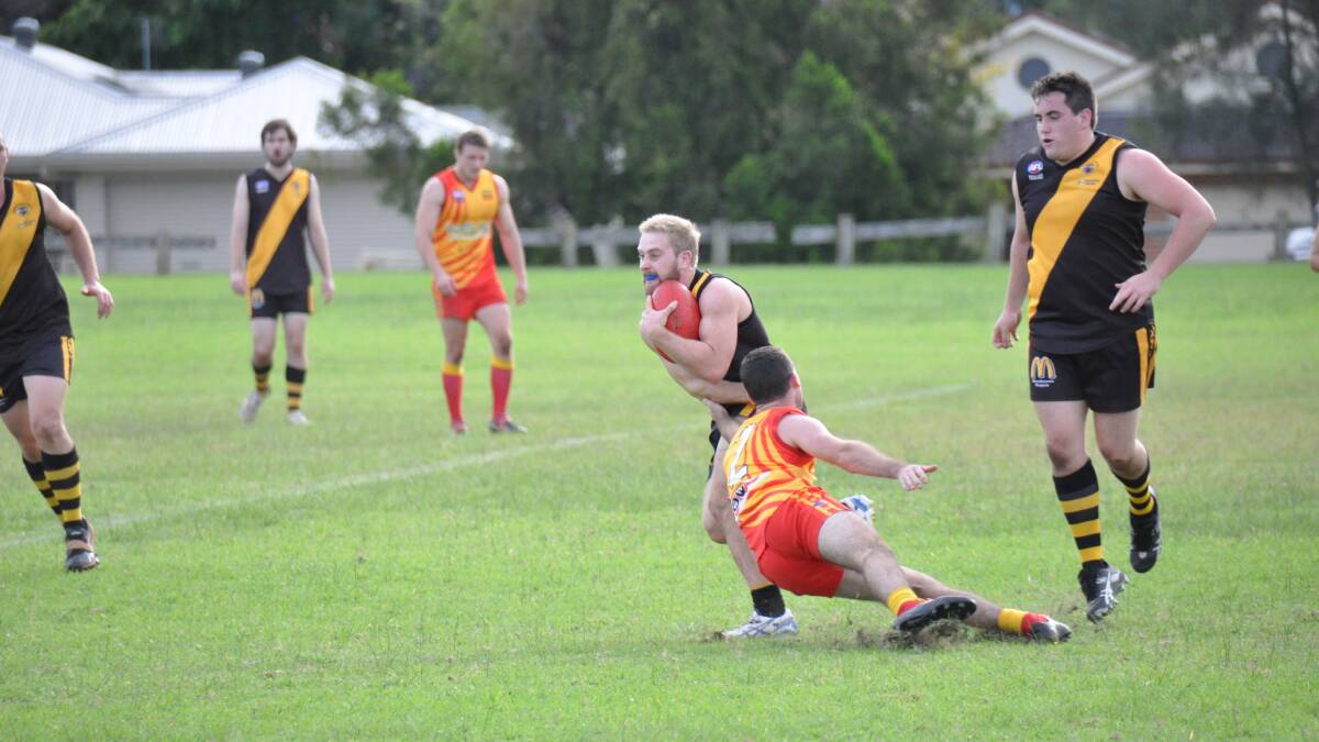 BOMADERRY: Bomaderry Tigers’ James Nicoll fends off a Shellharbour Suns player in his team’s win at Artie Smith Oval on Saturday. Photo: PATRICK FAHY 