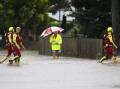 A Swift Water Rescue crew makes its way through flood waters on Friday in Laidley, Queensland. Picture: Getty Images