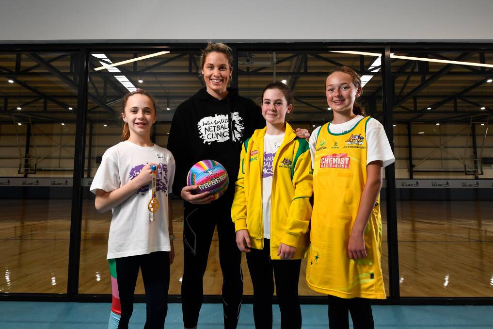 GOLDEN: Retired Australian Diamond Julie Corletto takes junior netballers Lucy Trigg, Lizzy Day and Charlotte Prendergast for a sneak peek at Ballarat's newest netball courts which will open this weekend. Picture: Adam Trafford