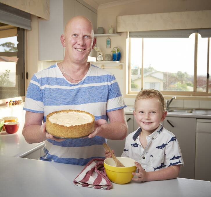 Cover model: Tura Beach Marty den Hartog shows off his famous lemon meringue cheesecake with his son Bailey. This is the photo that will be on the front cover of the local Yellow and White pages.  