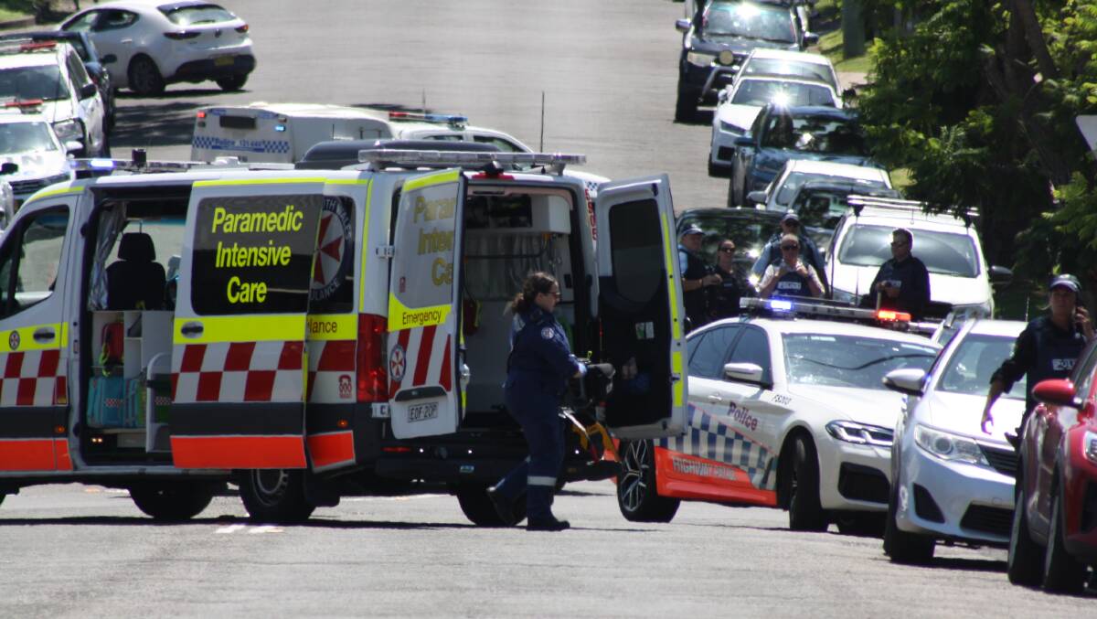 Paramedics rush in to help a man shortly after he was fatally shot by police in Nowra on Wednesday, January 10. Picture by Glenn Ellard