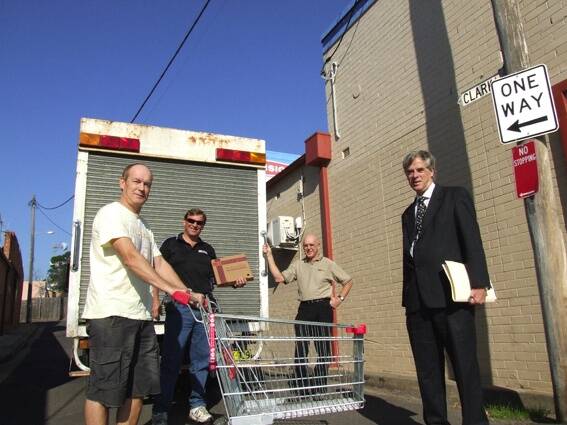 • Business owners Mick Tarlinton, Mal Barnes, Warren Page and Graeme Blomfield in Clark Lane with a small truck and a shopping trolley.