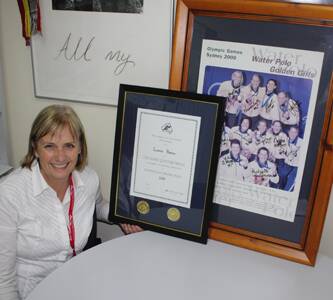 • Leanne Barnes with the Harry Quittner Medal citation and an autographed photo of the gold medal winning 2000 Australian women’s water polo team, an achievement that wouldn’t have come without her help.
