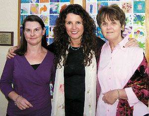Danielle Gibbons’ sisters Sharon and Corinne and mother Janet in front of some of the tiles displayed at the Canberra tribute.