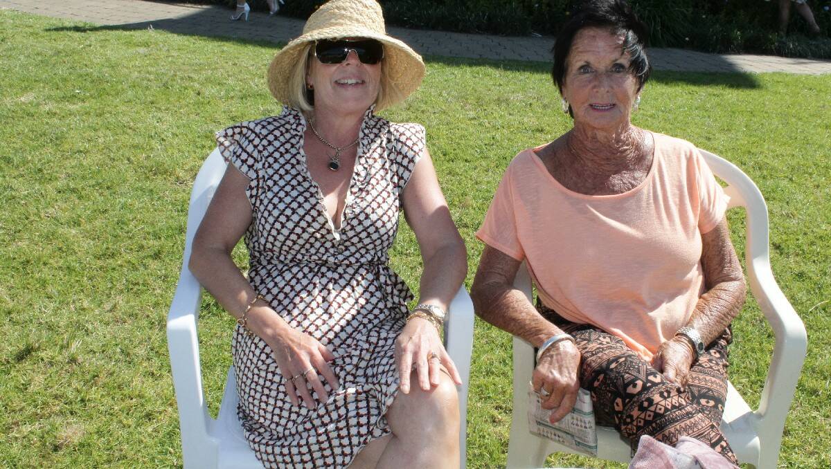 Linda McCabe and Patti Hand, both of Eden, catch in the sunshine at Sunday's Bega Cup races.