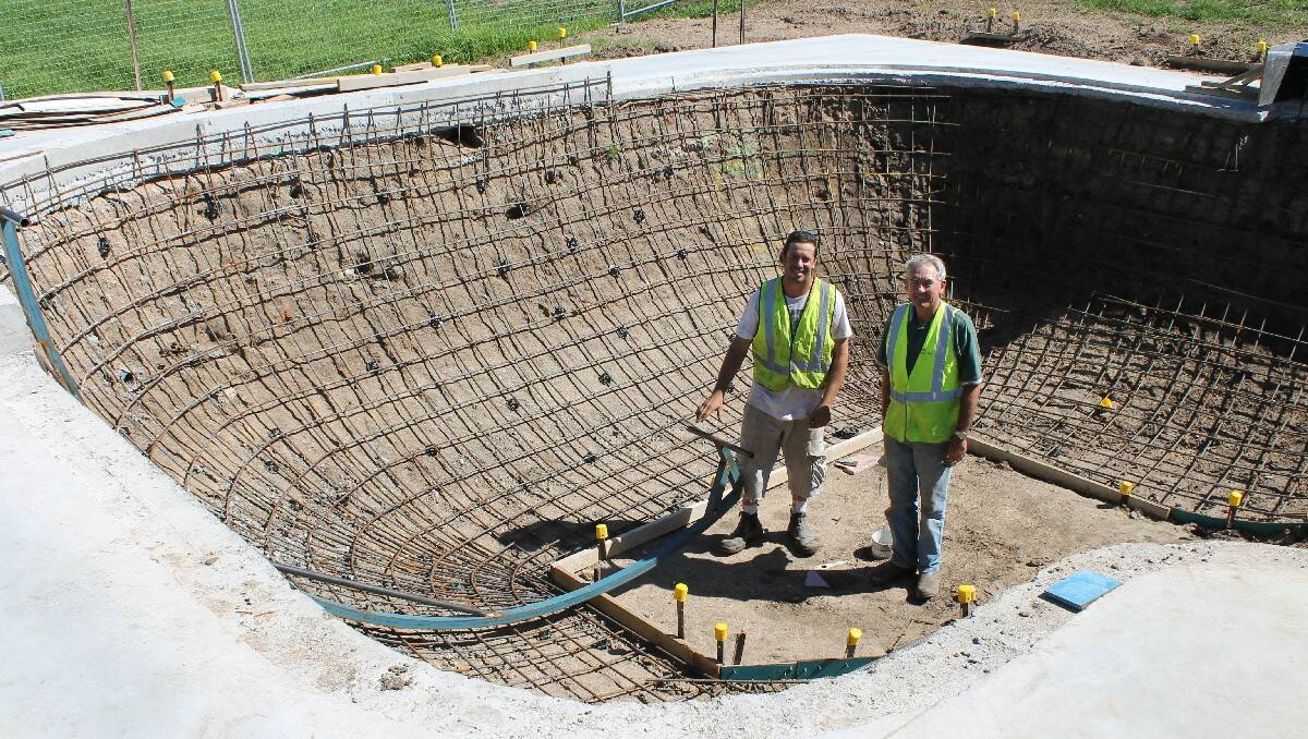 Designer Finn Askew (left) and project coordinator Bryson Banfield inspect the Bega Skate Park bowl, which is nearing completion.