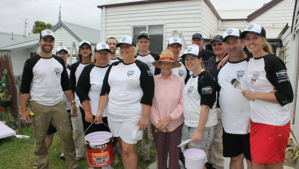 Mavis Wheeler (centre) with some of the many willing workers who painted her home on behalf of Berger’s Paint for a Mate this week, including project manager John Watkin of Inspirations Paint (second from right).