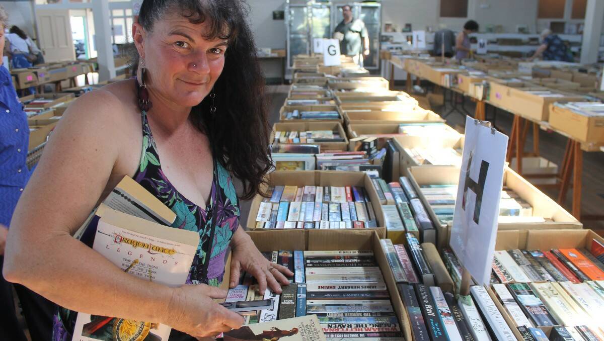 Ann-Louise Clark of Candelo browses the thousands of pre-loved books on offer at the Rotary Book Fair held in the Bega Showground pavilion.