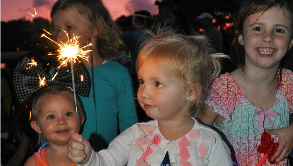 Phoebe Nagle, of Tathra, sparkles at a family friendly New Year’s Eve celebration at Ford Oval, organised by the Merimbula Chamber of Commerce. Photo: Denise Dion.