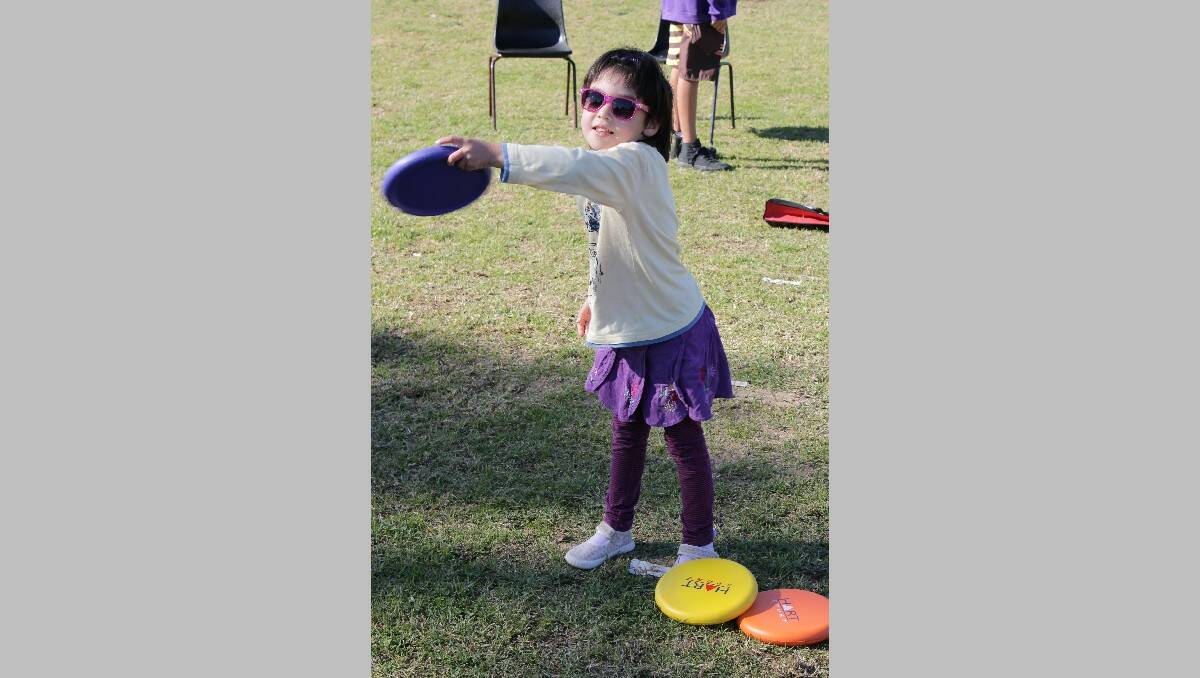  Emma Cook shows off her frisbee-throwing skills during a mini Olympics.