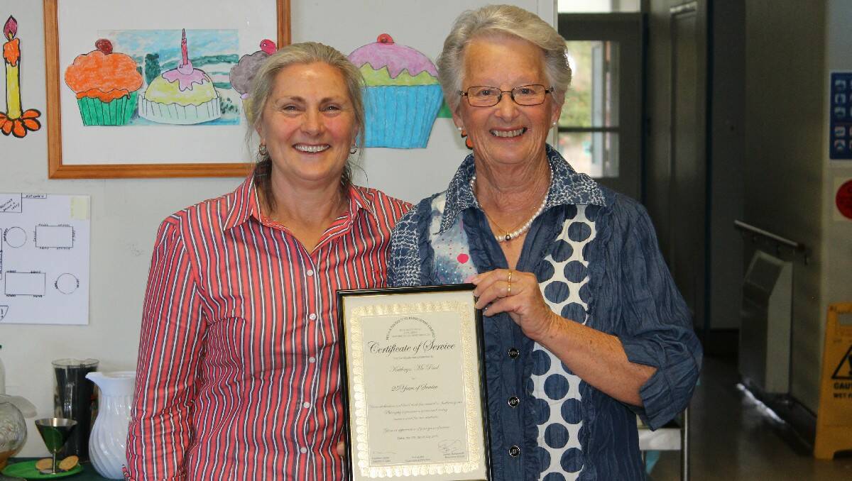 Kathryn McPaul is congratulated for her 25 years of service to Hillgrove House by board member Helen Slater.