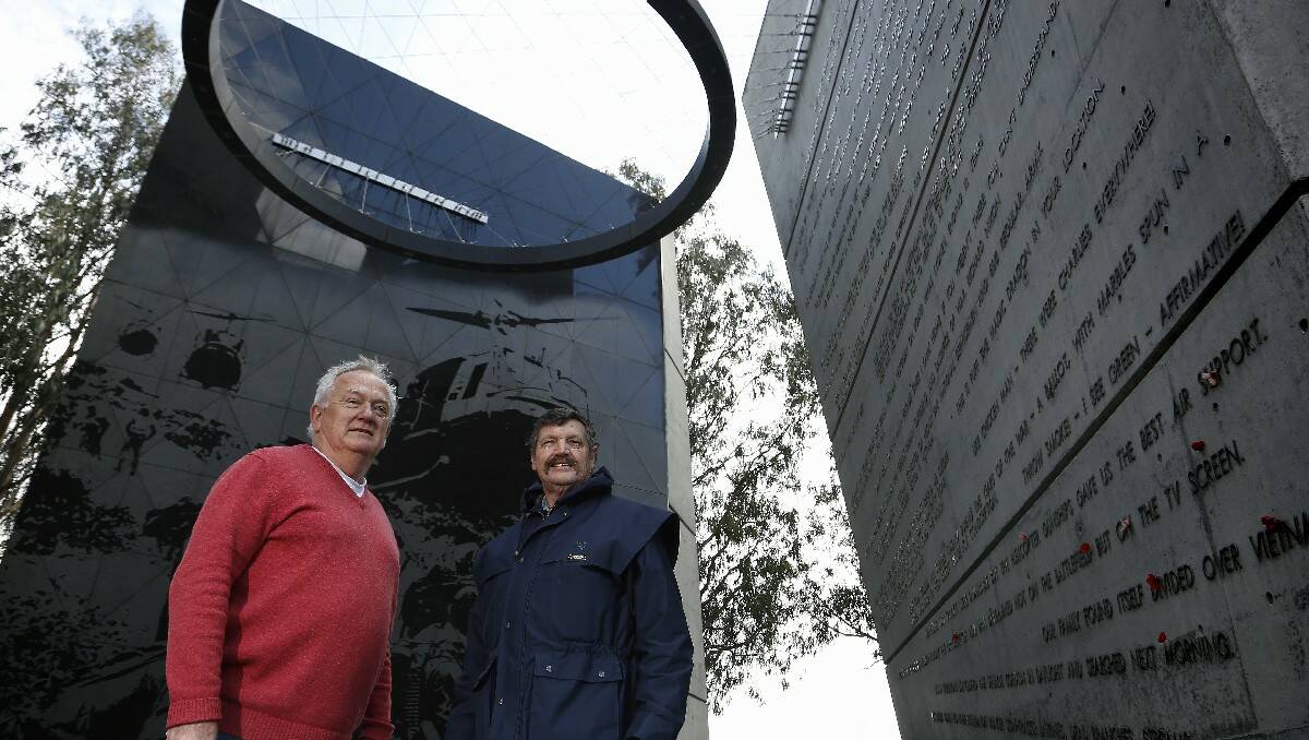 Vietnam veterans Ross Benton of Bendigo and Brian Pender – formerly of Bega – meet for the first time in 43 years at the Vietnam Memorial in Canberra. Photo: Jeffery Chan, Canberra Times.