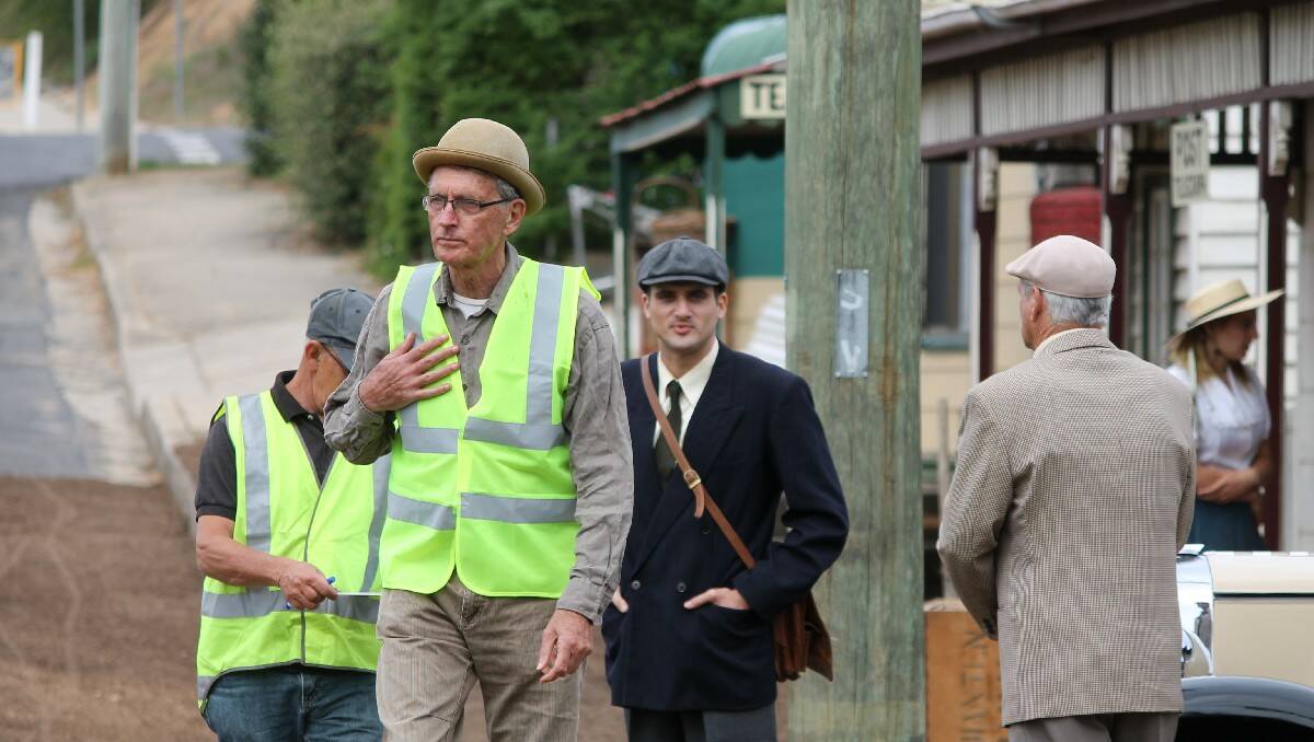 Director Tom Cowan (front) walks through the set at Candelo.