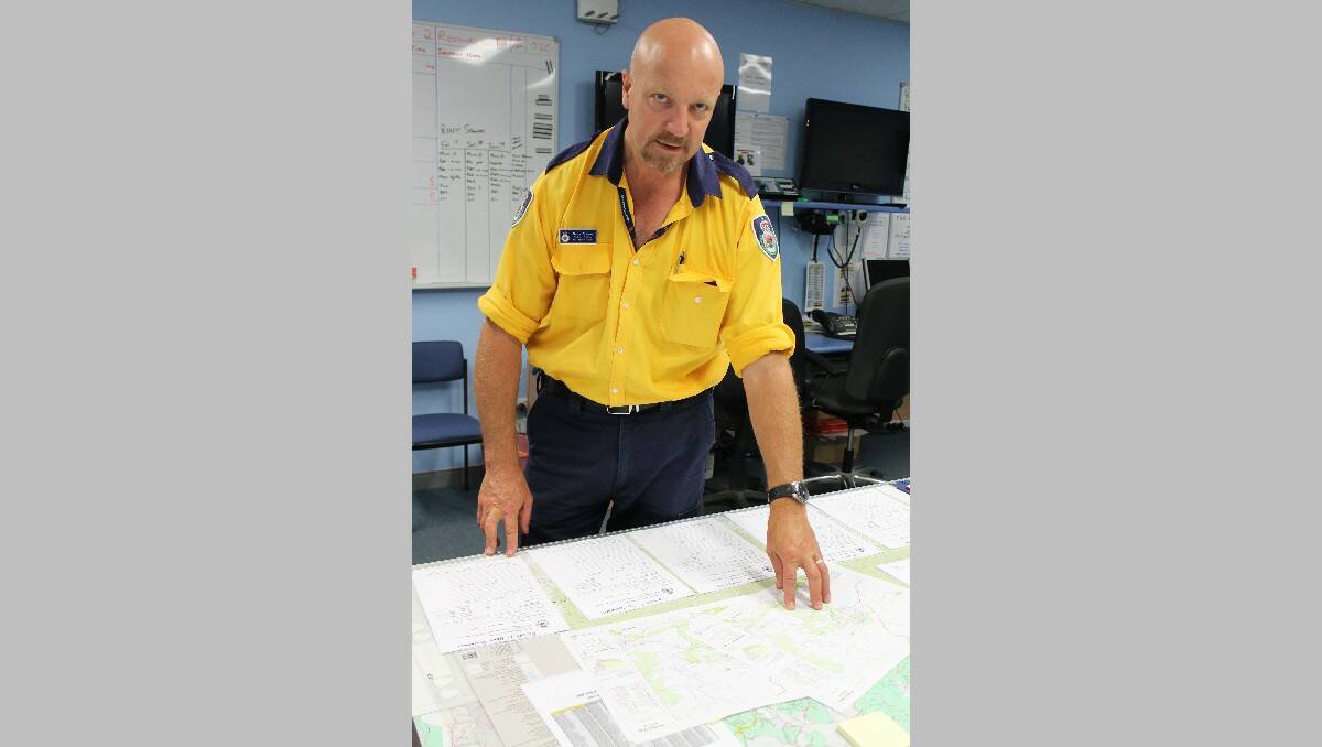 Far South Coast district officer Garry Cooper inspects a map of the Wagga Wagga region.