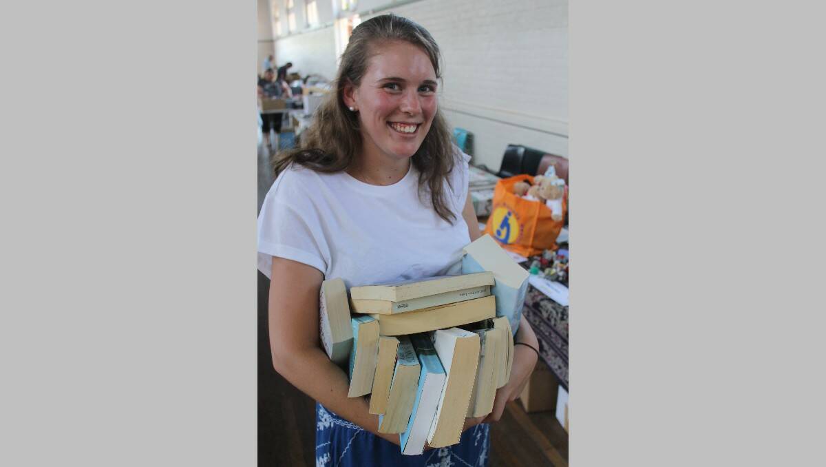 Rebecca Hof of Tura Beach heads to the till after making her selections during the Rotary Book Fair.