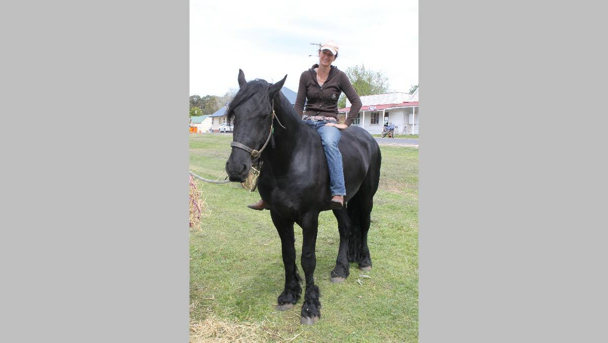 Sue Schepisi rides Frisco, the Friesian stallion.