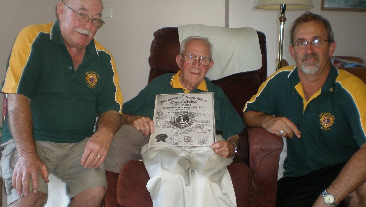 Kevin Ford (centre) shows off the Tathra Lions Club charter to president Peter Davis (left) and recruitment officer Anthony Dack.