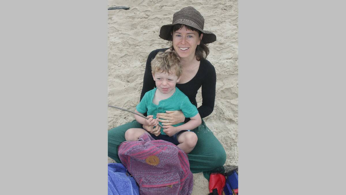 Bega’s Amanda Hackshall and her son Leon relax at Tathra Beach on Friday.