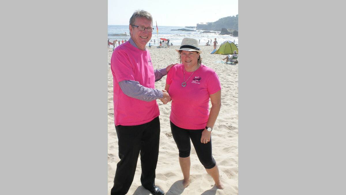 Tathra Wharf to Waves organising committee member Linda Badewitz-Dodd presents Bega Cheese executive chairman Barry Irvin with a Wharf to Waves shirt.