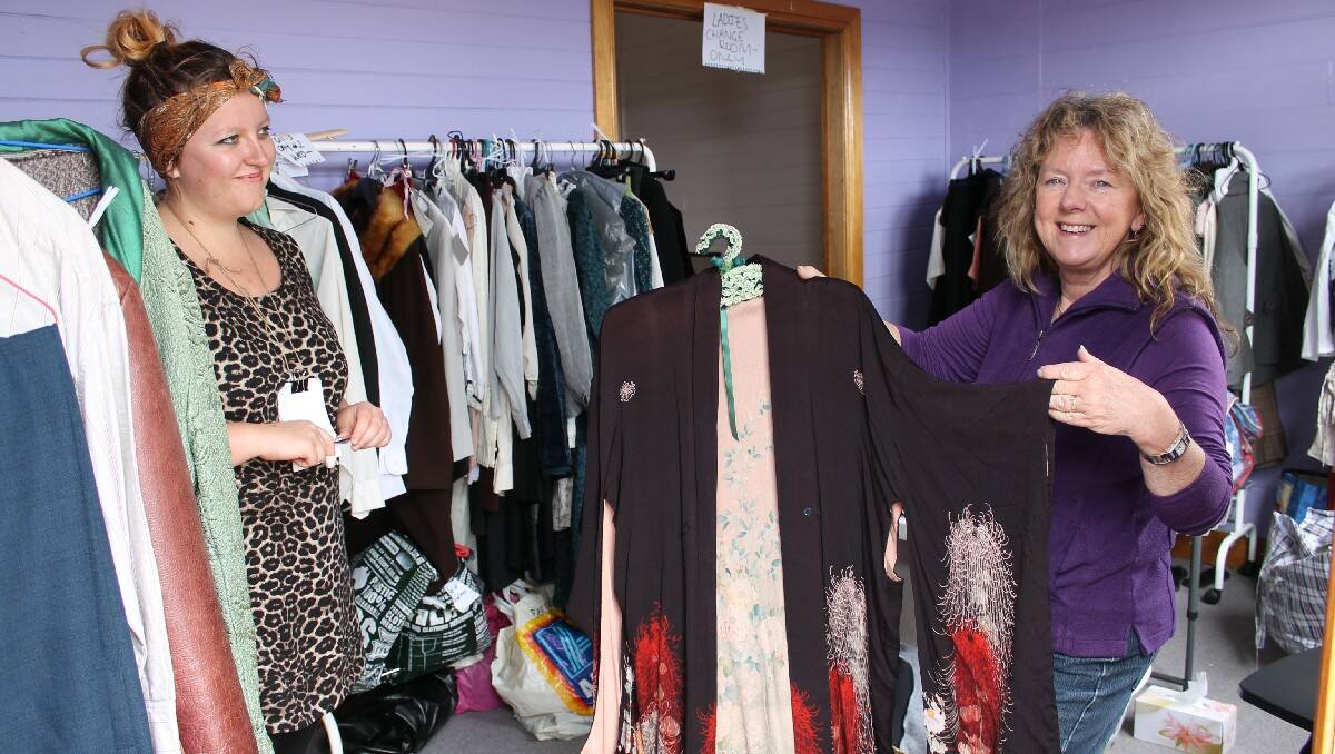 Tess Bertram-Jones and Robyn Whitby display the kimono which the leading actor will slip out of to life model.