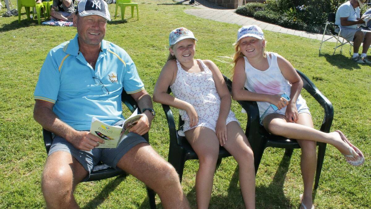 Relaxing in the sunshine are Tathra's Putvinas family, (from left) Ron, Laura, 10, and Sarah, 11.