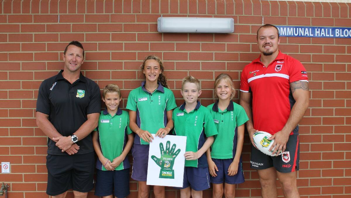 St George Illawarra Dragons ambassador Shaun Timmins (left) and the club's new prop Matt Groat visit Bega Valley Public School as part of the NRL's Community Carnival and Tackle Bullying campaign. They met with BVPS school captains (from left) Riley Lucas, Tarni Evans, Noah Murray and Josie Bonney.