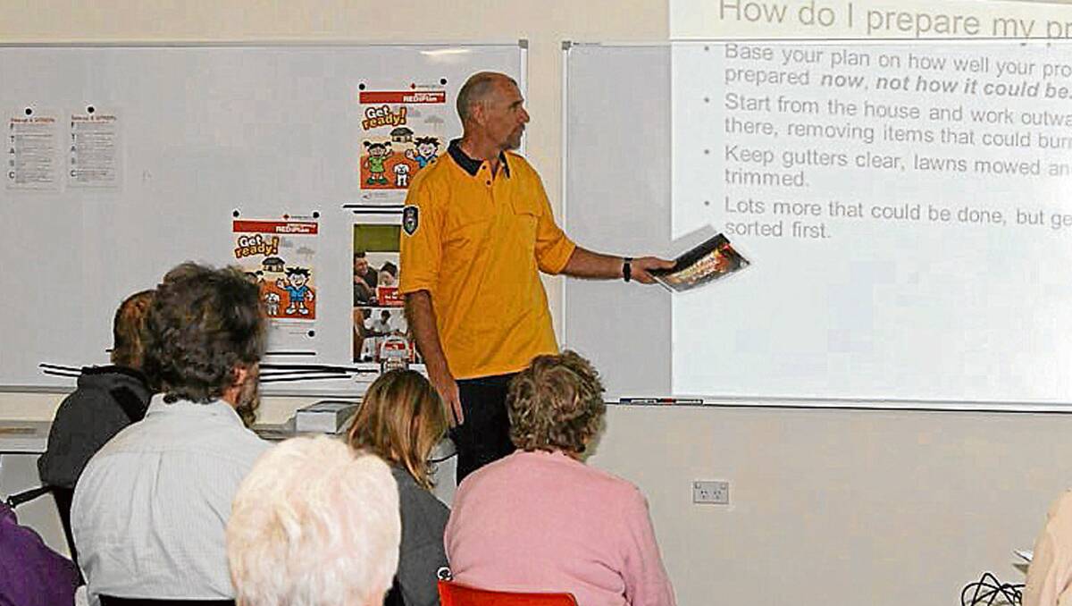 • Marty Webster from the RFS talks to locals at the Bemboka RFS station about being prepared for the bushfire season.