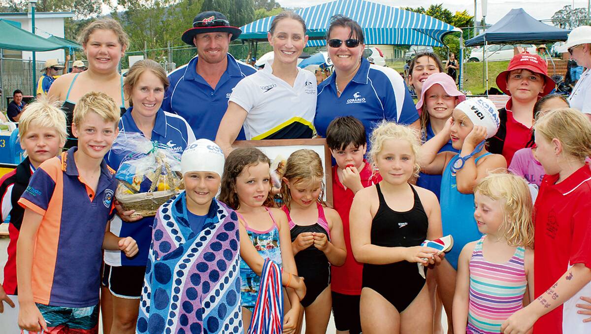 • Australian Olympic swimmer Sally Foster (back, centre) takes time out of her busy schedule to chat with swimmers at the Cobargo Pool during a development carnival last Saturday.
