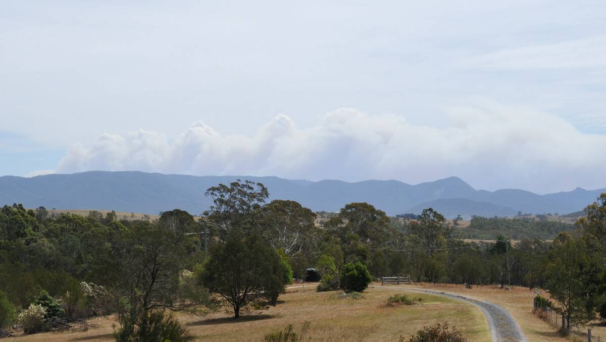 The smoke plume from a bushfire in the Kybeyan Range dominates the Bemboka skyline in this photo taken by Mogilla resident Bruce Cummings.