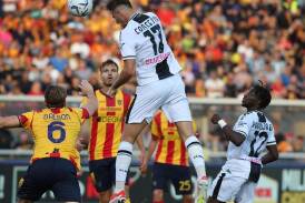 Lorenzo Lucca rises above the Lecce defence to score the opening goal in Udinese's 2-0 win. (EPA PHOTO)
