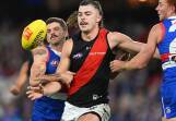 Essendon's Sam Draper (centre) will be sidelined for up to eight games after a knee arthroscopy. (James Ross/AAP PHOTOS)